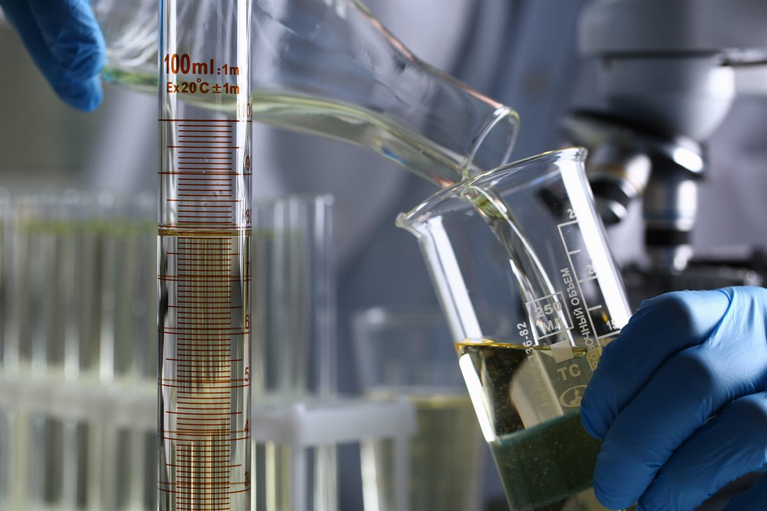 Solvent being measured and poured in a laboratory